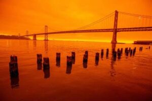 San Francisco's Golden Gate Bridge against a backdrop of fiery orange sky