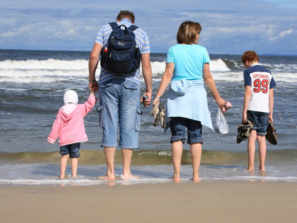 Family at the sandy beach of the Baltic Sea, Usedom, Germany